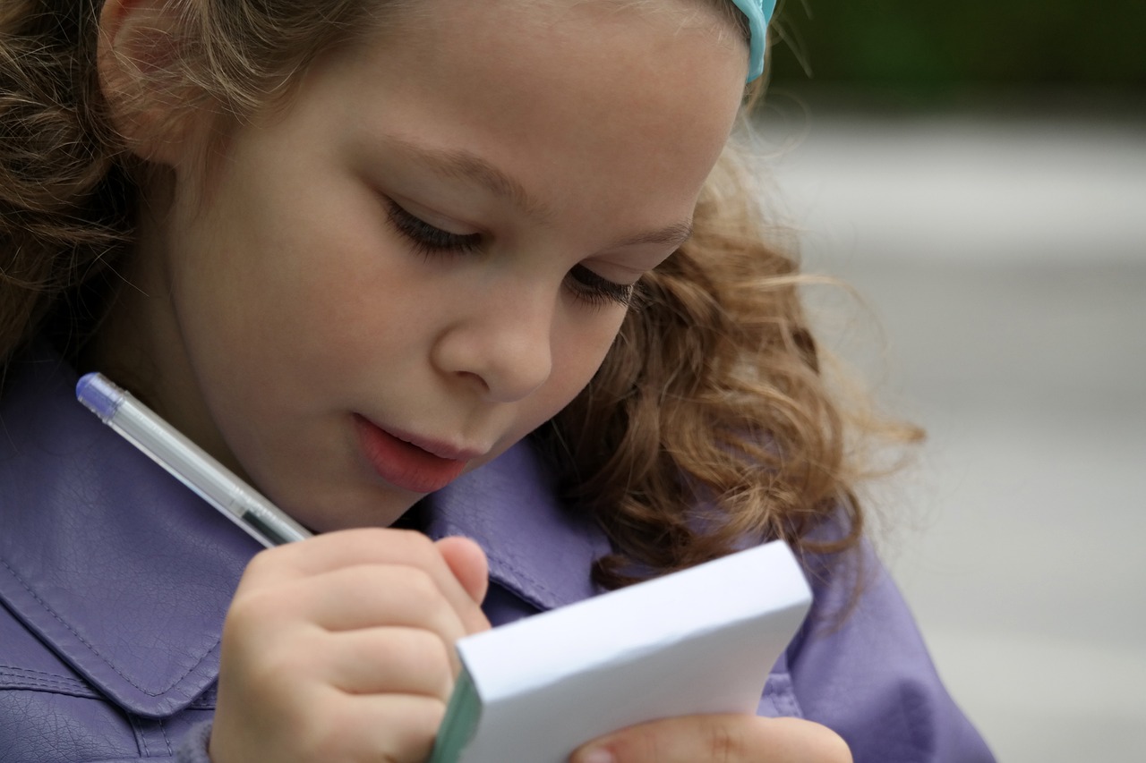 girl writing on a note pad